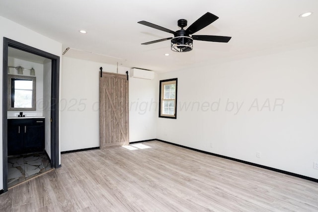 1802 Chama St, Amarillo, TX 79102 - unfurnished room featuring a barn door, plenty of natural light, light wood finished floors, recessed lighting, and a ceiling fan