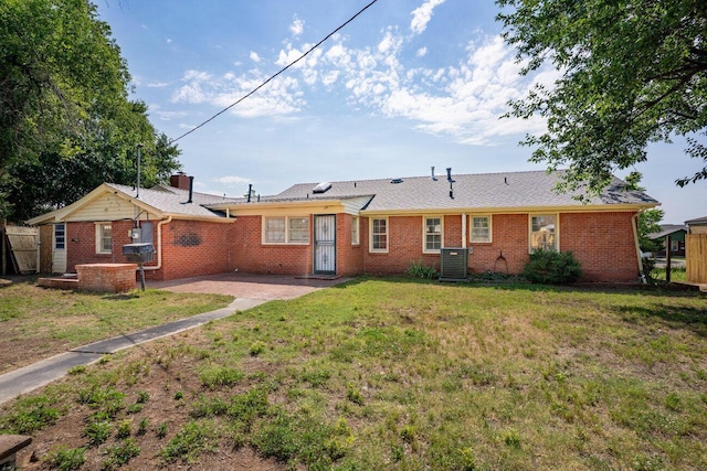 1802 Chama St, Amarillo, TX 79102 - rear view of property featuring a yard, brick siding, and a patio area
