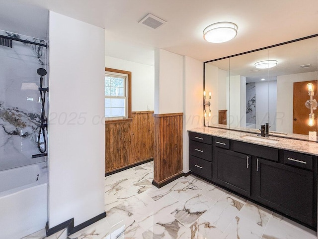1802 Chama St, Amarillo, TX 79102 - bathroom with wooden walls, vanity, wainscoting, marble look tiles, and a shower