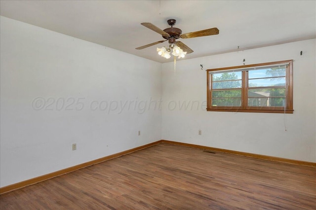 709 Franklin Ave, Panhandle, TX 79068 - unfurnished room with wood finished floors, baseboards, and a ceiling fan