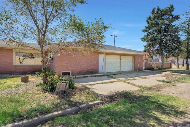 709 Franklin Ave, Panhandle, TX 79068 - view of property exterior with brick siding, a garage, driveway, and fence