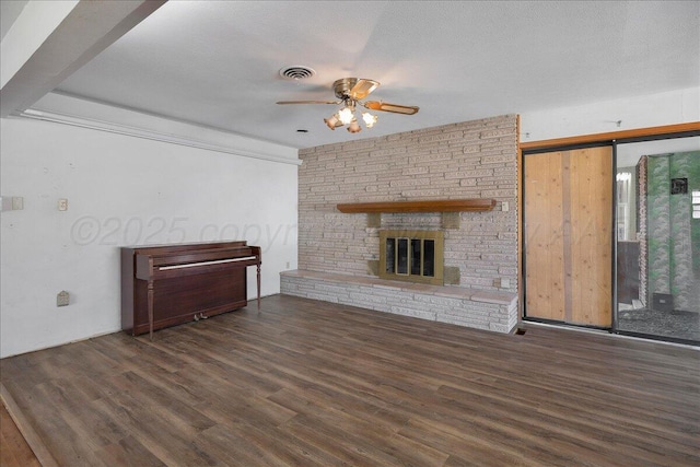 709 Franklin Ave, Panhandle, TX 79068 - unfurnished living room featuring a ceiling fan, wood finished floors, and a fireplace