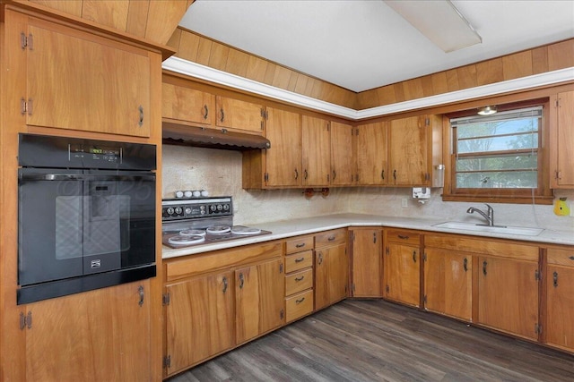 709 Franklin Ave, Panhandle, TX 79068 - kitchen with black oven, under cabinet range hood, a sink, light countertops, and cooktop