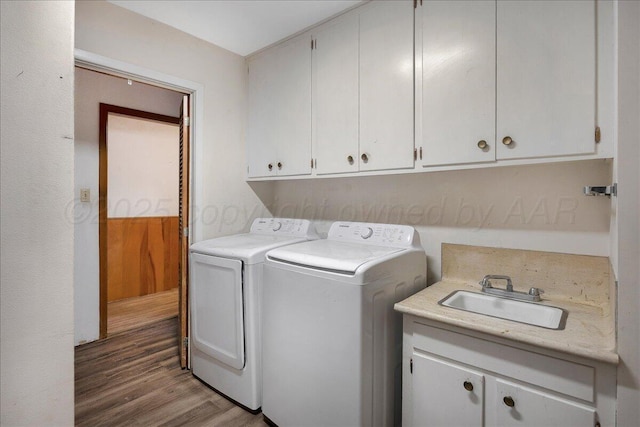 709 Franklin Ave, Panhandle, TX 79068 - washroom featuring cabinet space, washer and clothes dryer, and wood finished floors