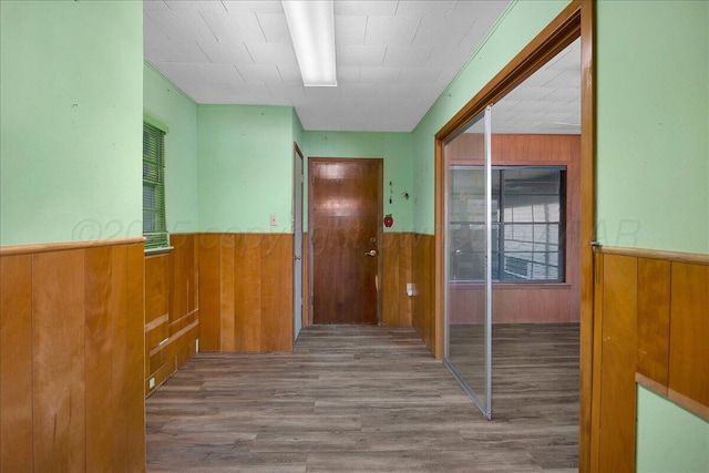 709 Franklin Ave, Panhandle, TX 79068 - hall with a wainscoted wall, wood walls, and wood finished floors
