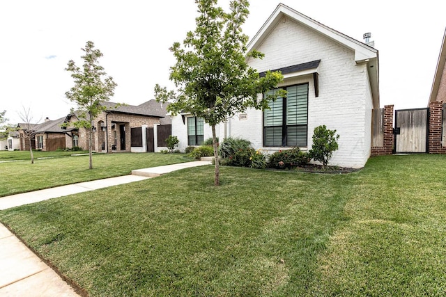 5904 Nancy Ellen St, Amarillo, TX 79119 - view of front facade with brick siding and a front lawn