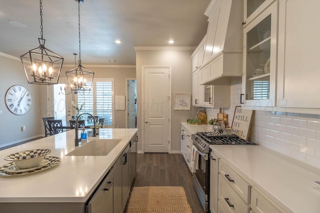 5904 Nancy Ellen St, Amarillo, TX 79119 - kitchen with gas stove, crown molding, white cabinetry, light countertops, and a chandelier