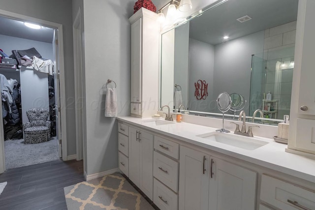 5904 Nancy Ellen St, Amarillo, TX 79119 - full bath featuring double vanity, wood finished floors, a walk in closet, and a shower with door