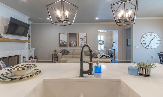 5904 Nancy Ellen St, Amarillo, TX 79119 - kitchen featuring a chandelier, ornamental molding, light countertops, a brick fireplace, and open floor plan