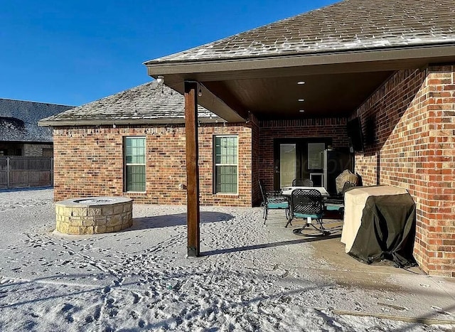 view of patio / terrace with a fire pit and a grill