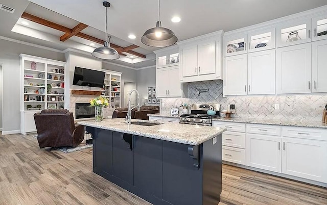 kitchen featuring coffered ceiling, white cabinetry, beamed ceiling, and stainless steel range with gas cooktop