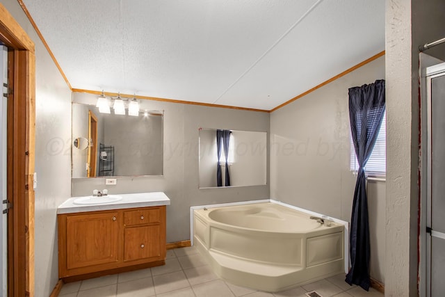 bathroom featuring a washtub, vanity, a textured ceiling, and ornamental molding