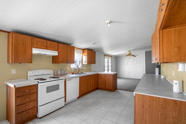 kitchen featuring ceiling fan, sink, kitchen peninsula, a textured ceiling, and white appliances