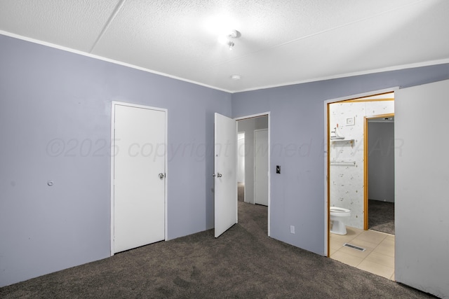 unfurnished bedroom with ensuite bath and carpet