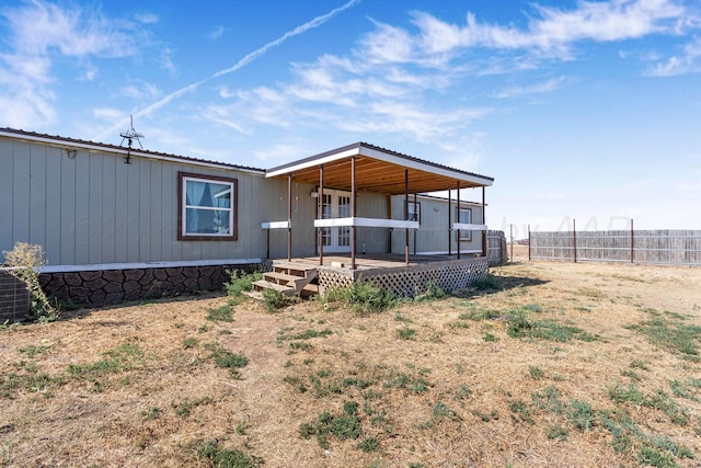 back of property with a wooden deck