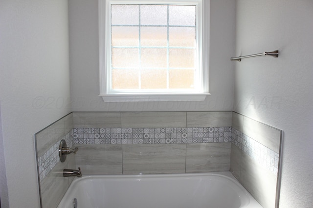 bathroom with a tub to relax in