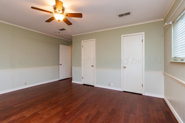 unfurnished bedroom with baseboards, visible vents, ornamental molding, and hardwood / wood-style floors