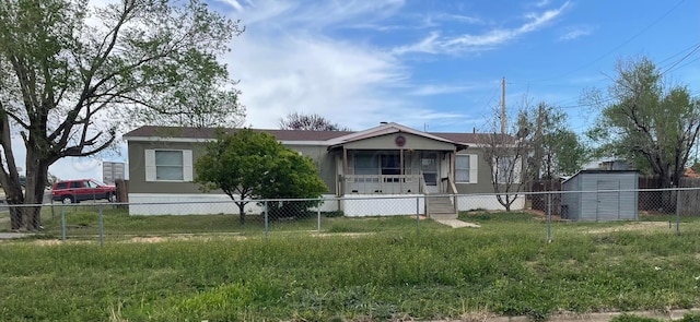 manufactured / mobile home featuring fence private yard and a porch