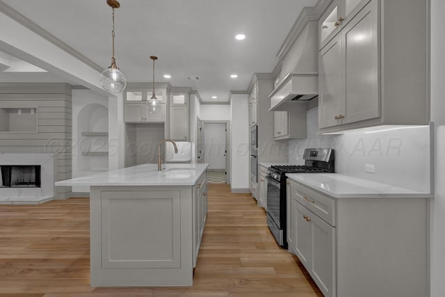 5505 Sheridan St, Amarillo, TX 79119 - kitchen featuring stainless steel appliances, custom range hood, light wood-type flooring, glass insert cabinets, and decorative backsplash