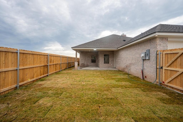 5505 Sheridan St, Amarillo, TX 79119 - back of house with brick siding, a fenced backyard, a patio, and a shingled roof