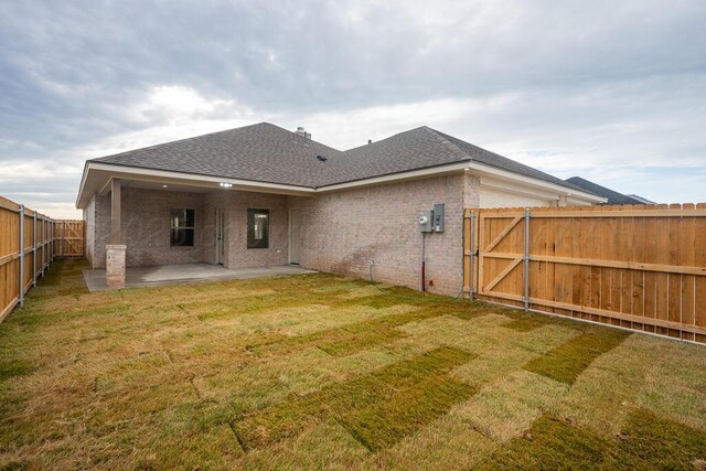 5505 Sheridan St, Amarillo, TX 79119 - back of property featuring a gate, brick siding, a fenced backyard, and a patio