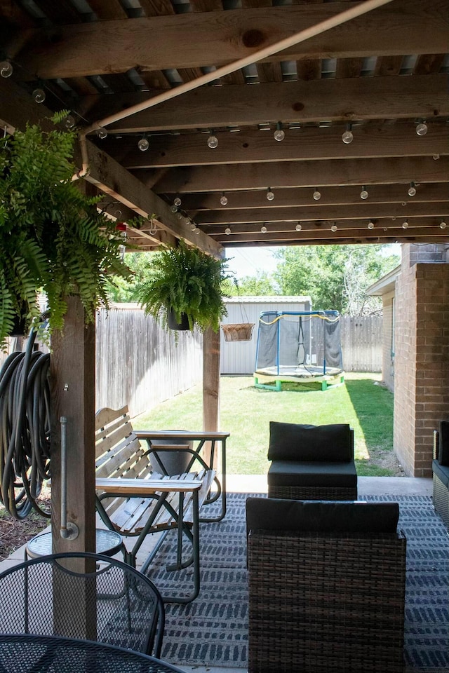view of patio featuring a fenced backyard and a trampoline