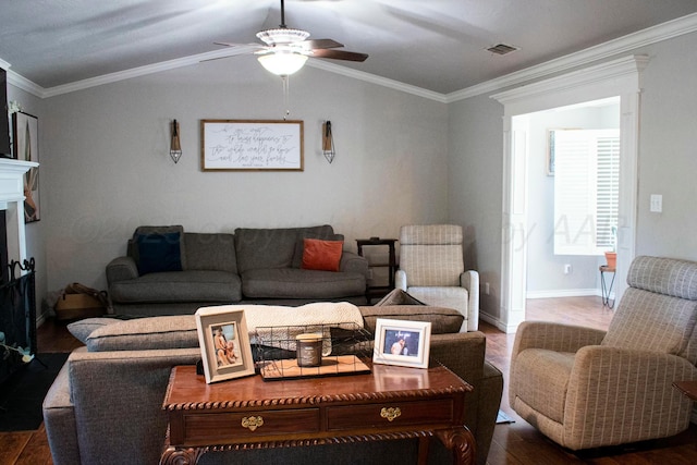living room with visible vents, ornamental molding, ceiling fan, wood finished floors, and vaulted ceiling