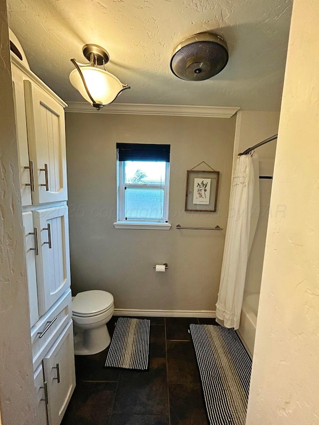 full bathroom featuring toilet, a textured ceiling, baseboards, and ornamental molding