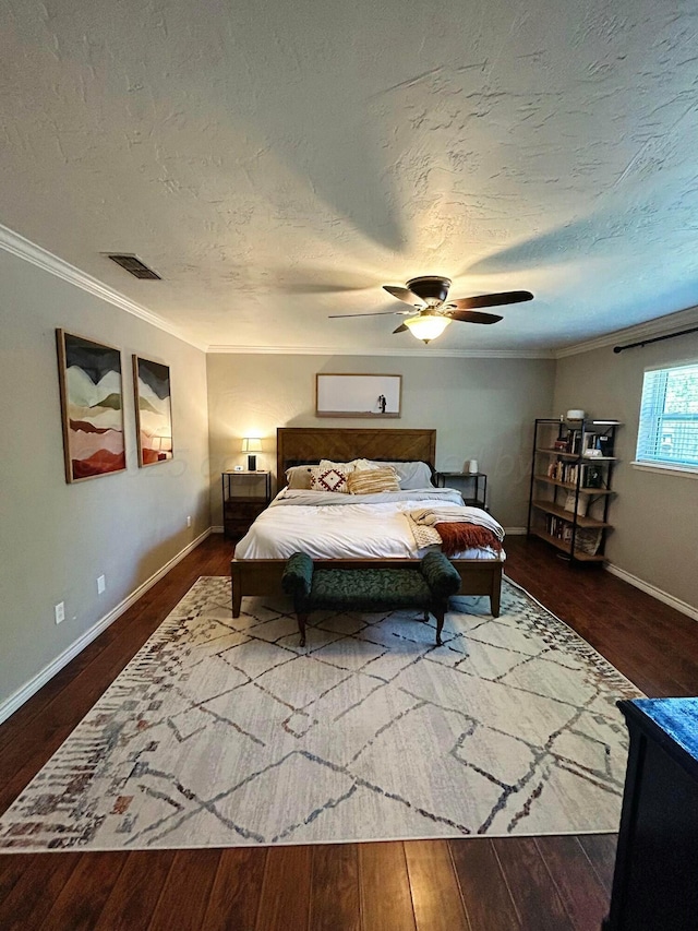 bedroom featuring visible vents, ornamental molding, and dark wood finished floors