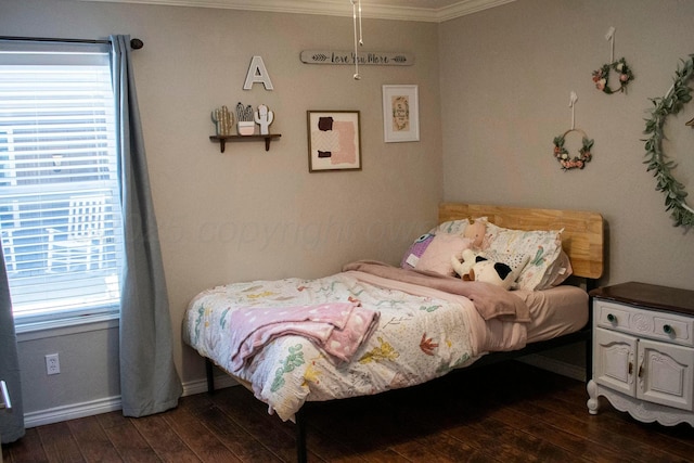 bedroom featuring baseboards, crown molding, and dark wood finished floors