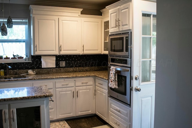kitchen featuring a sink, appliances with stainless steel finishes, and white cabinetry