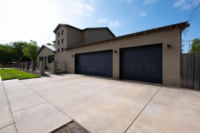1600 S Milam St, Amarillo, TX 79102 - view of home's exterior featuring brick siding, concrete driveway, and a garage