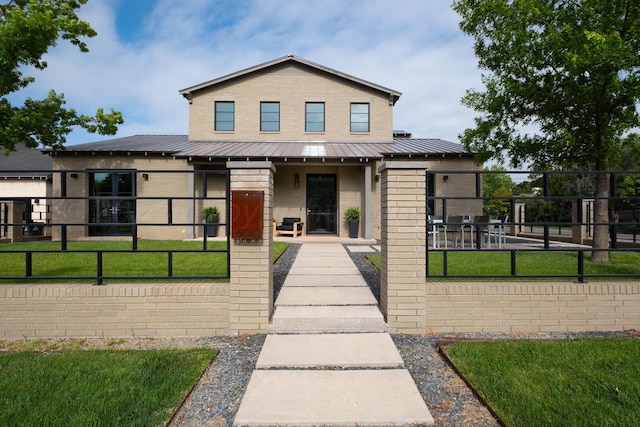 1600 S Milam St, Amarillo, TX 79102 - view of front facade with brick siding, metal roof, covered porch, and a standing seam roof