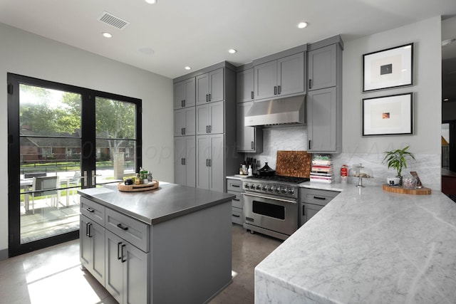 1600 S Milam St, Amarillo, TX 79102 - kitchen with designer range, under cabinet range hood, gray cabinetry, backsplash, and recessed lighting
