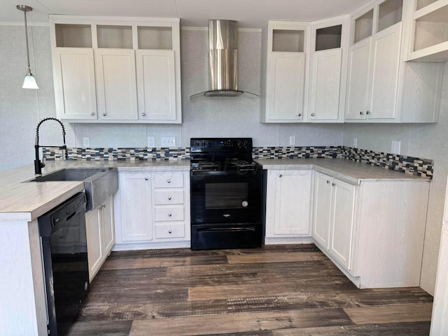 6 Honeywood Pl, Dalhart, TX 79023 - kitchen with tasteful backsplash, wall chimney exhaust hood, light countertops, dark wood-style floors, and black appliances