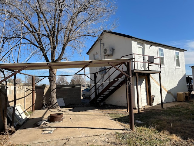 525 SE 2nd St, Tulia, TX 79088 - rear view of house with stairs, stucco siding, a patio, and a wooden deck