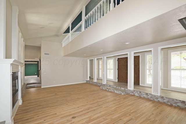 3801 Deann Dr, Amarillo, TX 79121 - unfurnished living room with light wood finished floors and a glass covered fireplace