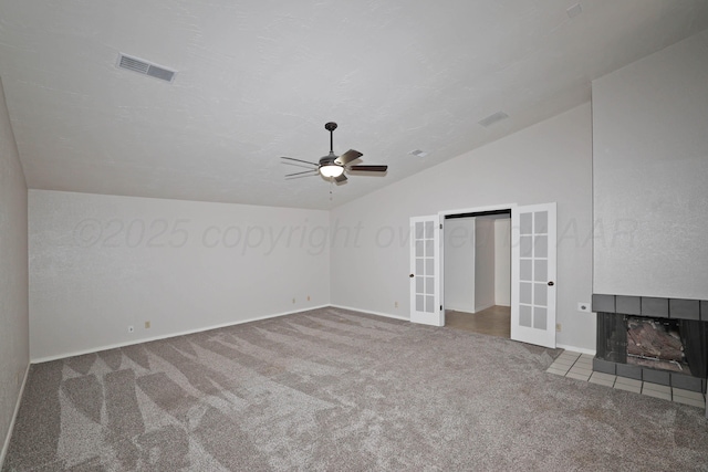 3801 Deann Dr, Amarillo, TX 79121 - unfurnished bedroom with french doors, vaulted ceiling, carpet floors, a tile fireplace, and a ceiling fan