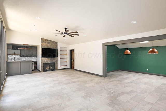 3801 Deann Dr, Amarillo, TX 79121 - unfurnished living room with ceiling fan, lofted ceiling, recessed lighting, a tile fireplace, and built in features