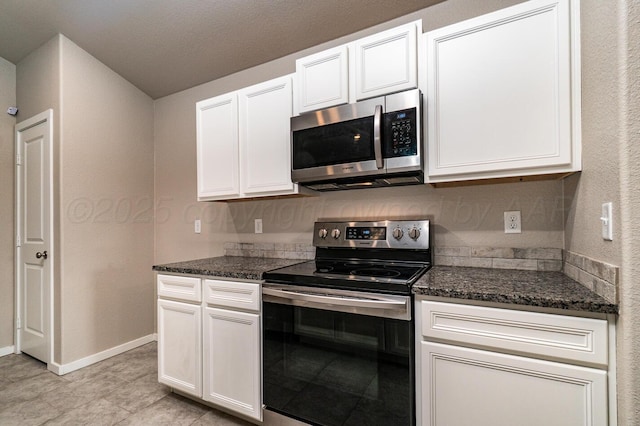 5004 Hinson St, Amarillo, TX 79118 - kitchen featuring appliances with stainless steel finishes, white cabinetry, and dark stone counters