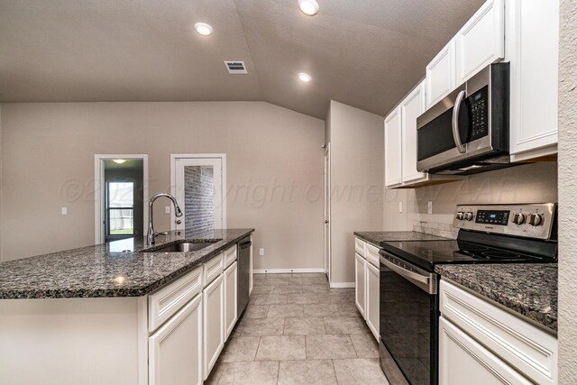 5004 Hinson St, Amarillo, TX 79118 - kitchen featuring appliances with stainless steel finishes, lofted ceiling, dark stone countertops, white cabinets, and recessed lighting