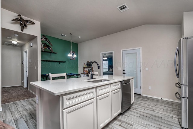 606 Elgin St, Amarillo, TX 79118 - kitchen featuring a sink, stainless steel appliances, wood tiled floors, white cabinets, and a center island with sink