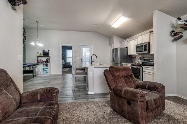 606 Elgin St, Amarillo, TX 79118 - living room featuring vaulted ceiling, baseboards, and dark wood-type flooring