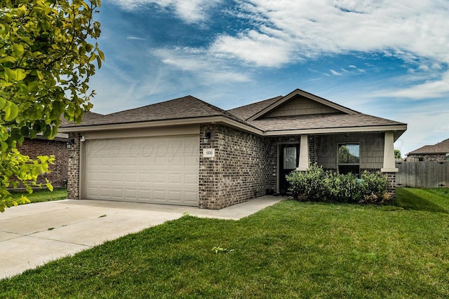 606 Elgin St, Amarillo, TX 79118 - view of front of home featuring a garage, driveway, brick siding, and a shingled roof