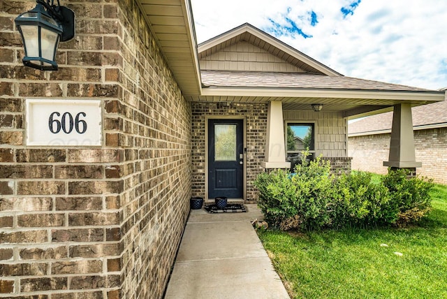 606 Elgin St, Amarillo, TX 79118 - doorway to property featuring brick siding and a shingled roof