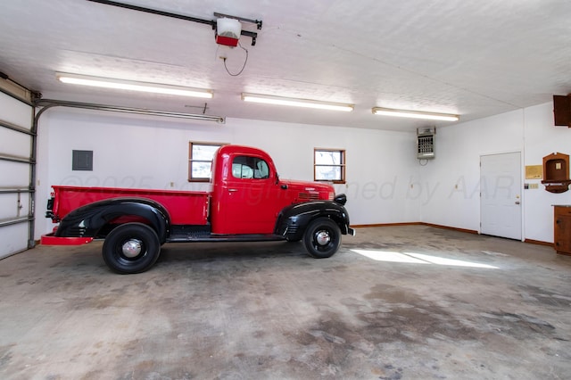 garage featuring baseboards and a garage door opener