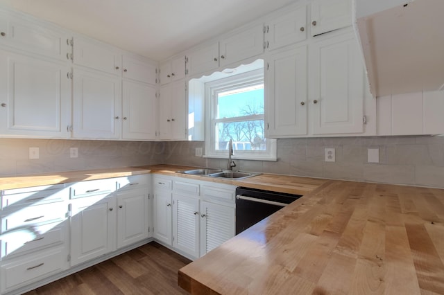 kitchen featuring dark wood-style floors, black dishwasher, butcher block counters, white cabinets, and a sink