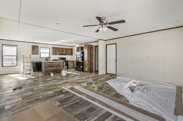 unfurnished living room with hardwood / wood-style flooring and ceiling fan