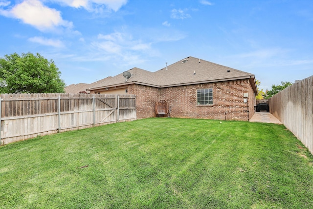 7404 Southbend Dr, Amarillo, TX 79119 - rear view of house featuring a fenced backyard, a shingled roof, and brick siding