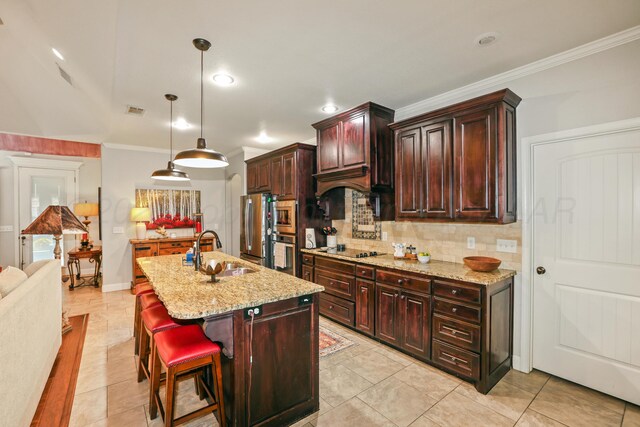 7404 Southbend Dr, Amarillo, TX 79119 - kitchen featuring appliances with stainless steel finishes, tasteful backsplash, light stone countertops, crown molding, and an island with sink